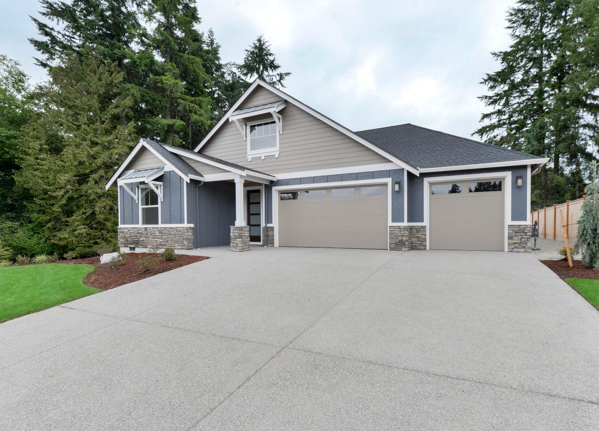 a house with a large driveway and a garage door