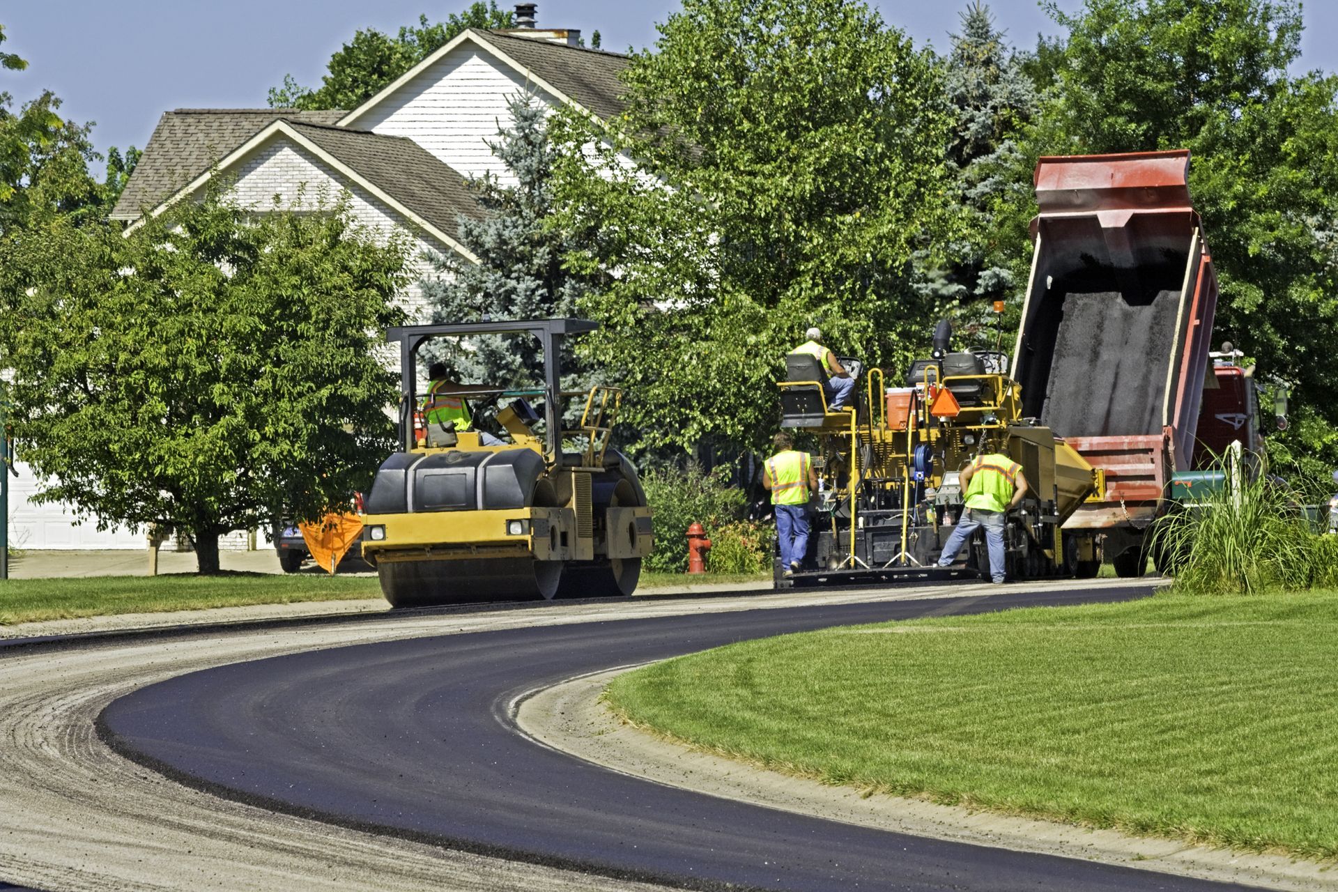 a road is being paved in a residential neighborhood