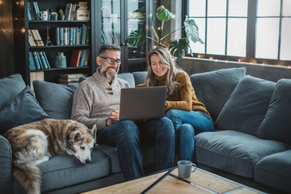 Couple Using Their Laptop — Colorado Springs, CO — Home Heating Service, Inc. Couple Using Their Laptop — Colorado Springs, CO — Home Heating Service, Inc.