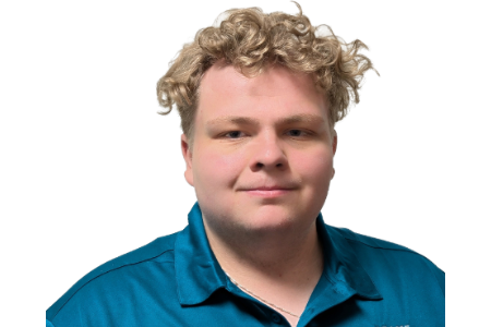 A person with curly, light-colored hair, wearing a teal collared shirt, looks directly ahead against a white background.