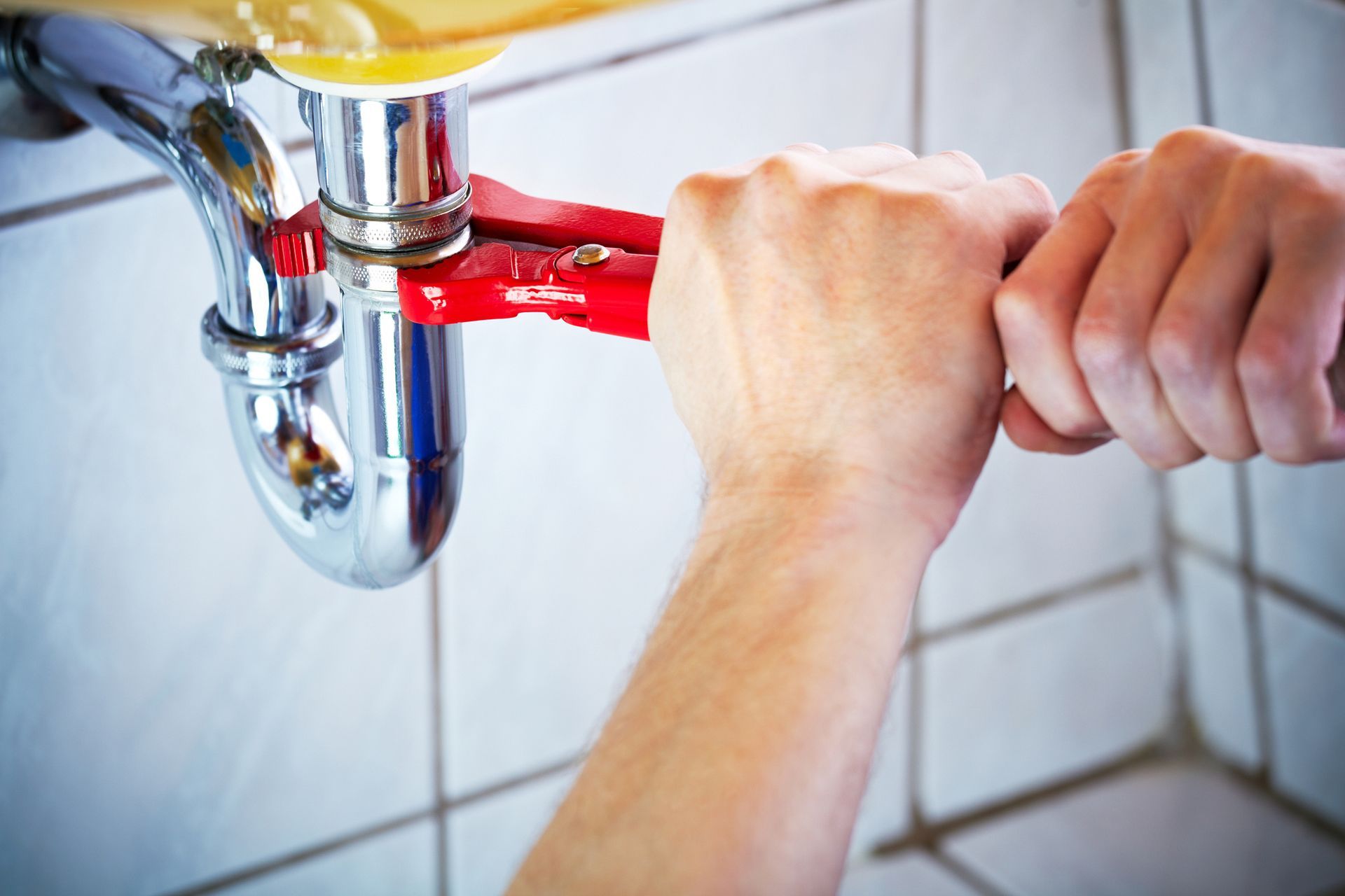 Holding Wrench and Fixing a Sink — Colorado Springs, CO — Home Heating Service, Inc.