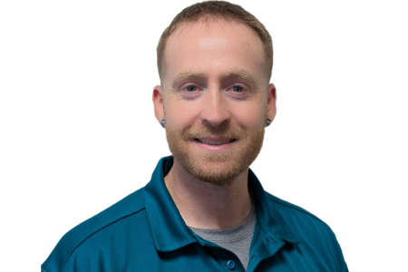 A person with short hair and a beard, wearing a teal polo shirt and earrings, smiling against a white background.