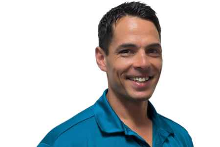 A person with short dark hair smiling while wearing a teal polo shirt against a plain white background.