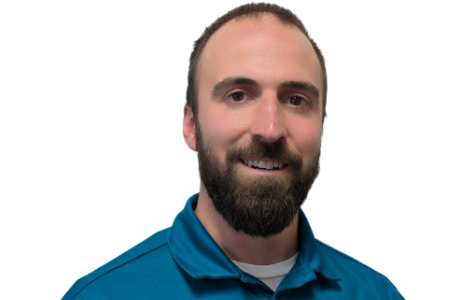 A man with a beard, wearing a teal polo shirt, looks toward the camera with a neutral expression against a white background.