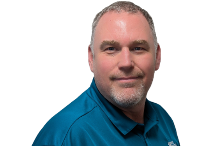 Headshot of a man with short brown hair and a goatee, wearing a teal polo shirt against a white background.