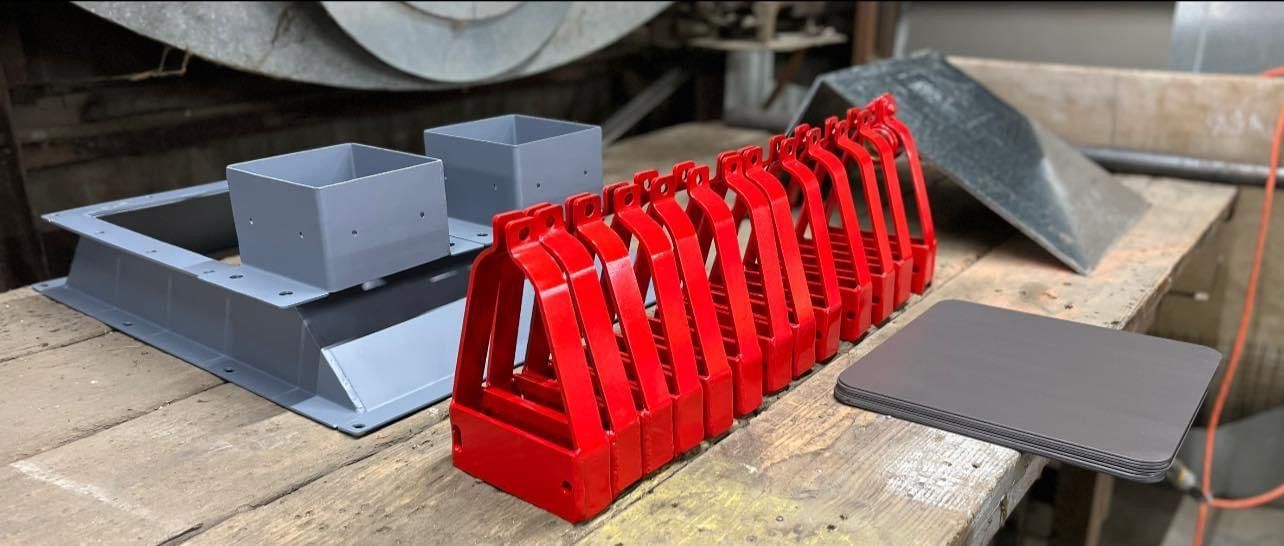 a bunch of red objects are sitting on a wooden table .
