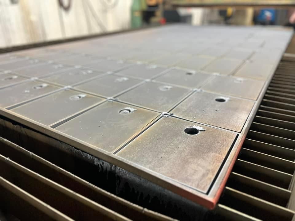 a large piece of metal is sitting on top of a machine .