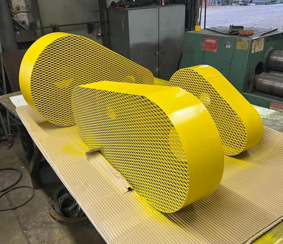 two yellow pieces of metal are sitting on a table