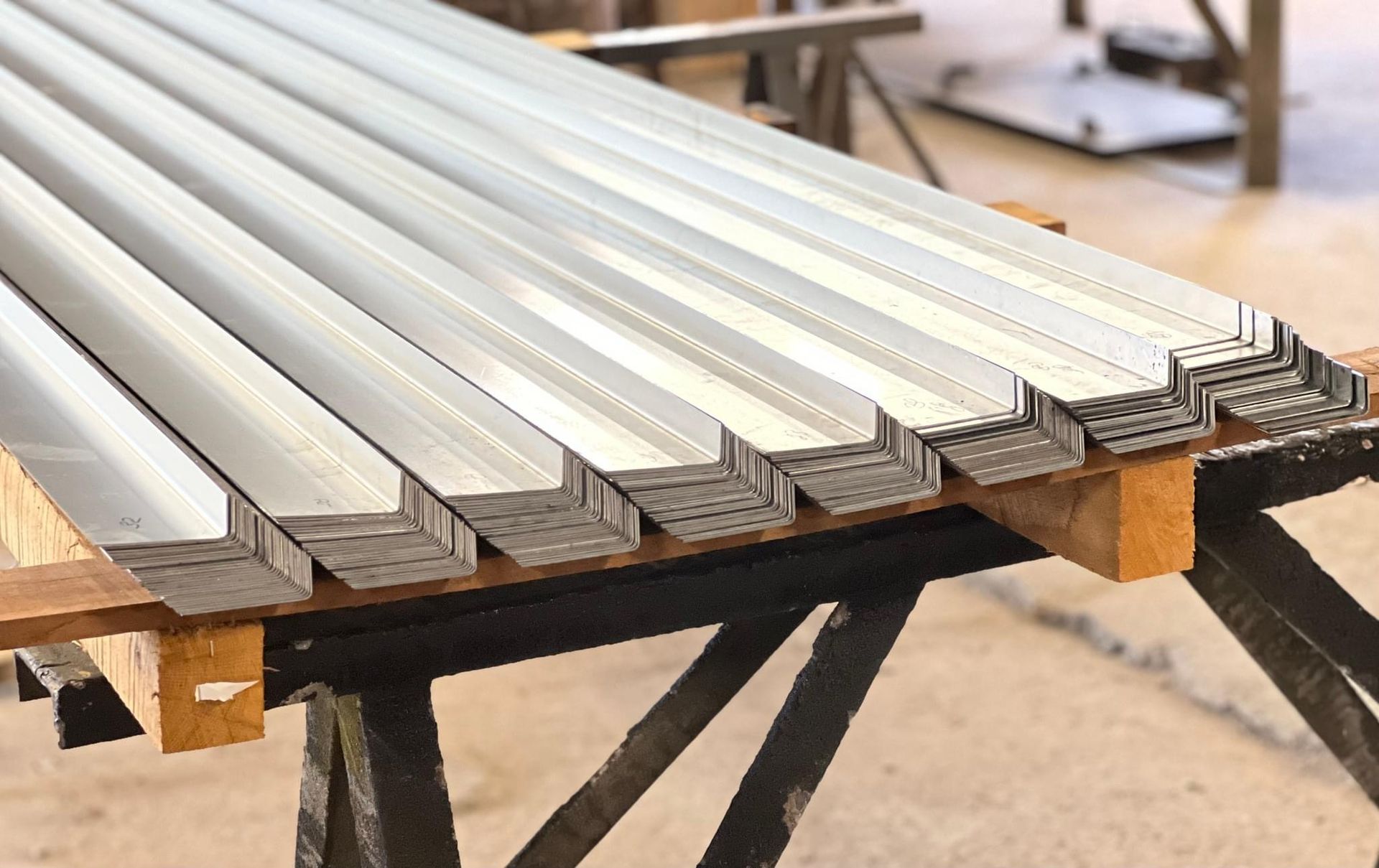 a stack of metal sheets sitting on top of a wooden table .