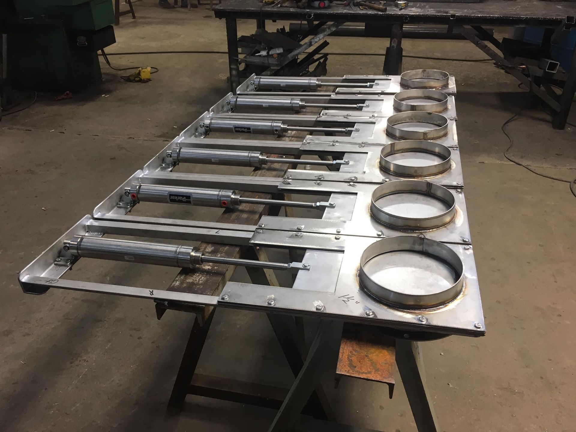 a row of metal pieces sitting on top of a wooden table