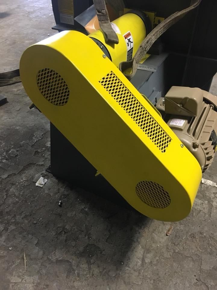 a yellow machine with a warning label on it