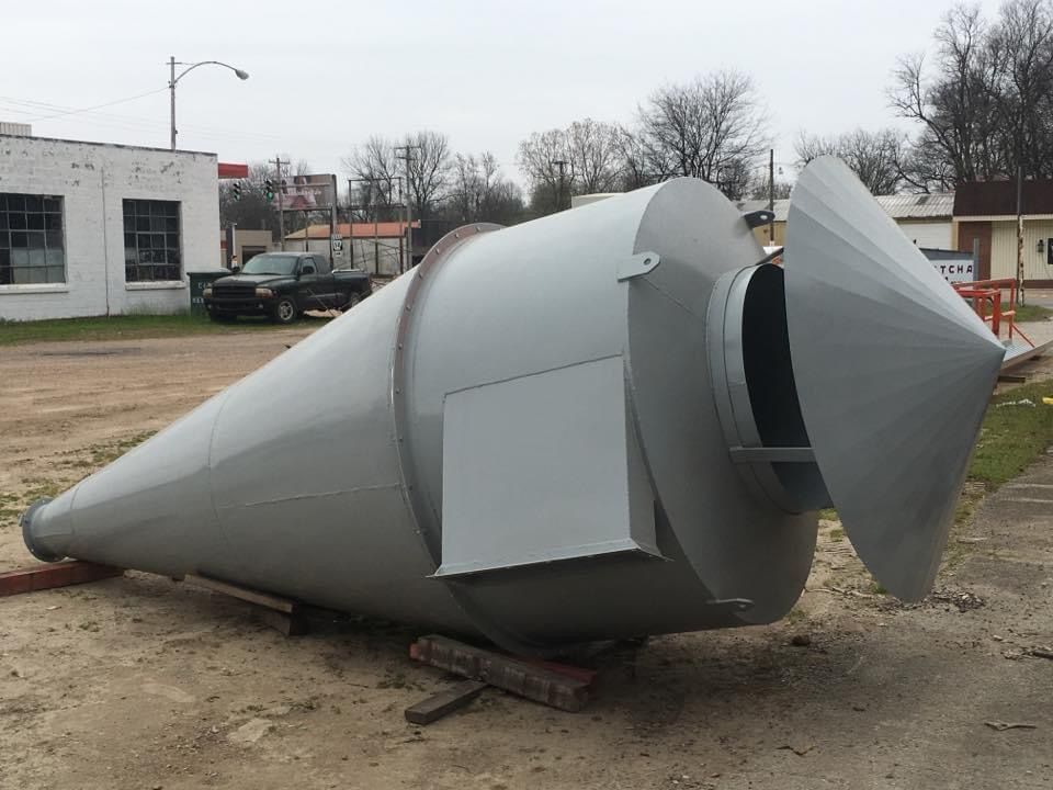 a large cone shaped object is sitting in a parking lot