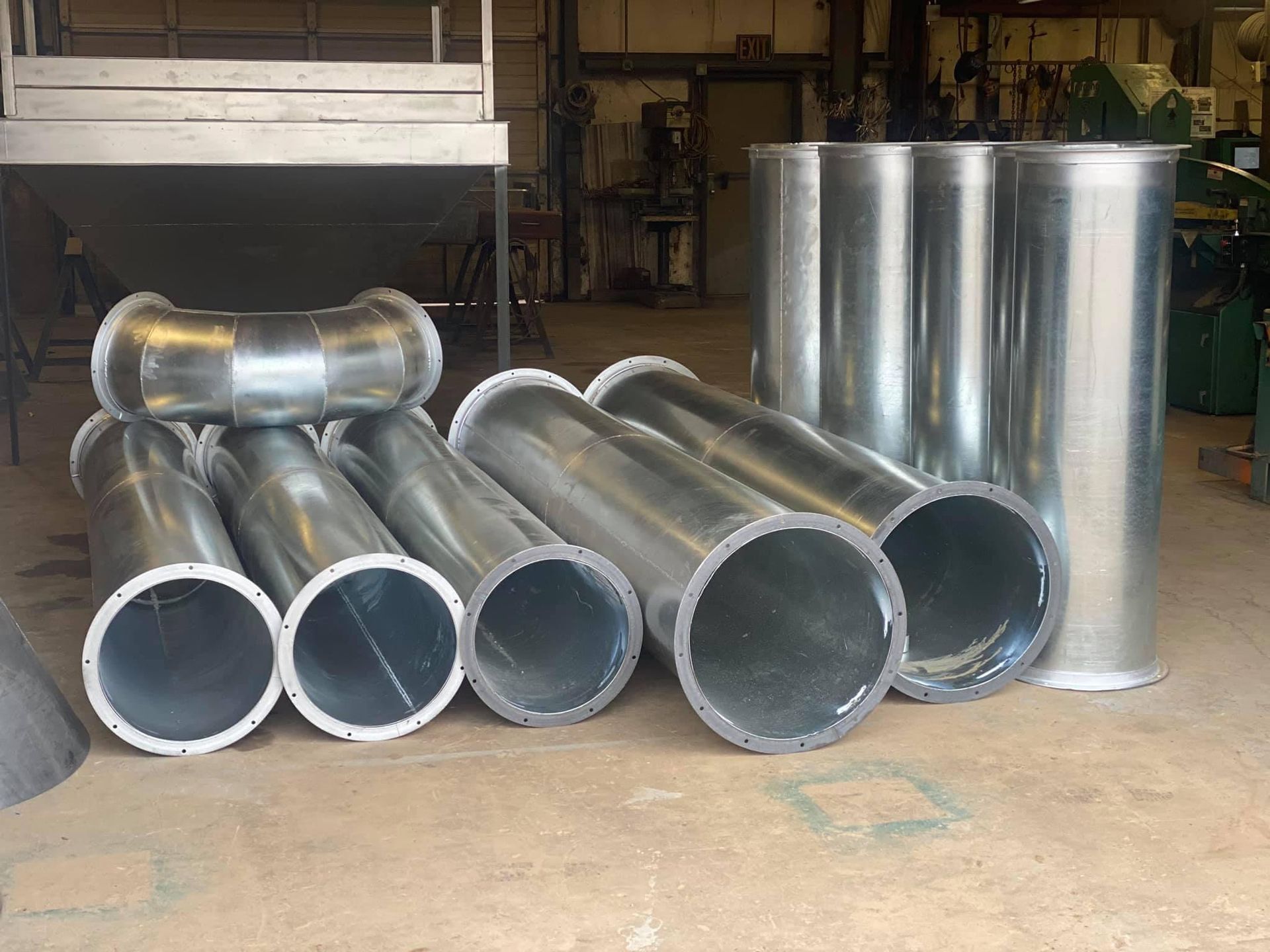 a bunch of metal pipes are stacked on top of each other
