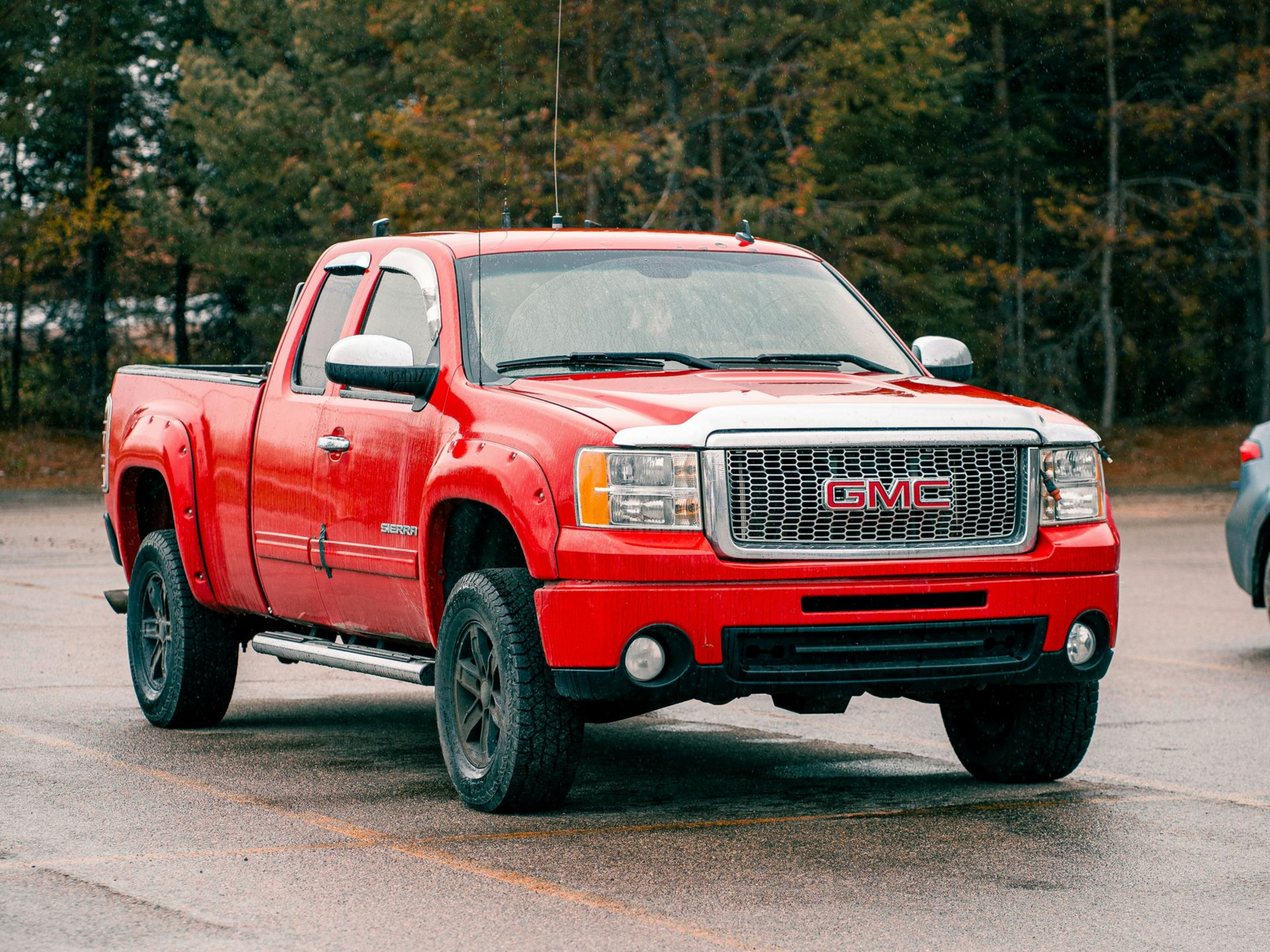 A red GMC truck in a parking lot