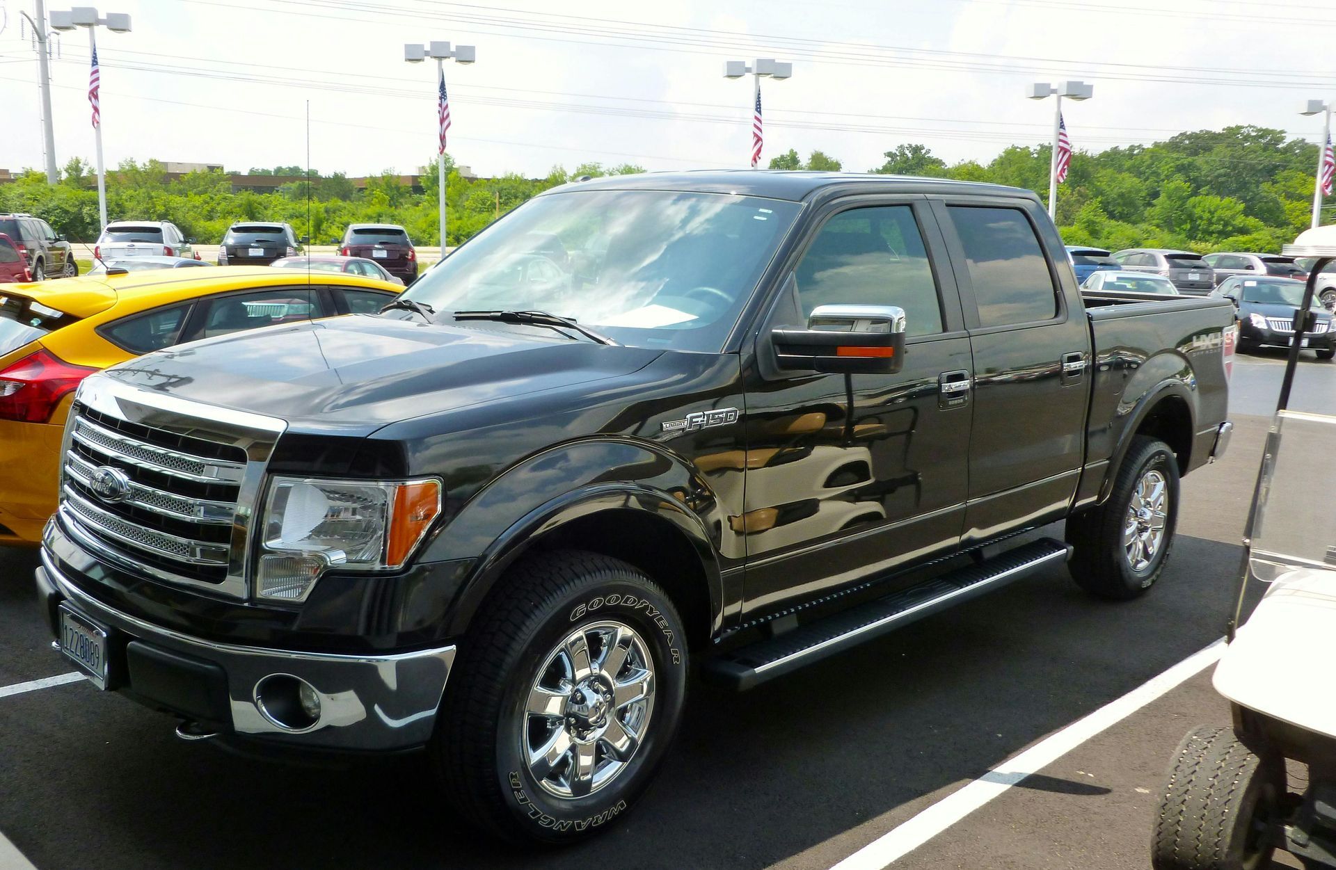 A black Ford truck in a parking lot.