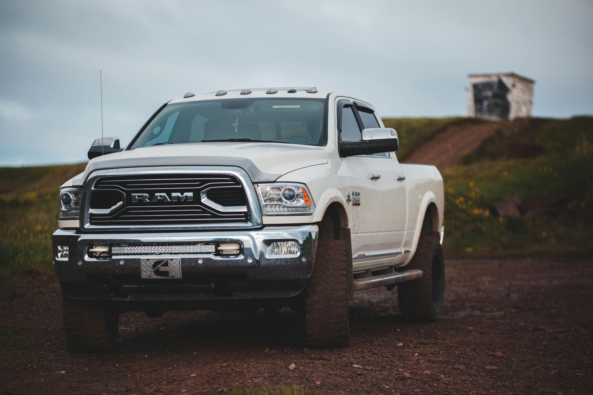 a white RAM truck in a field
