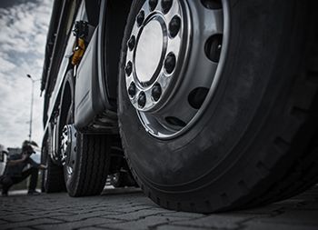 A man fixing a semi tire
