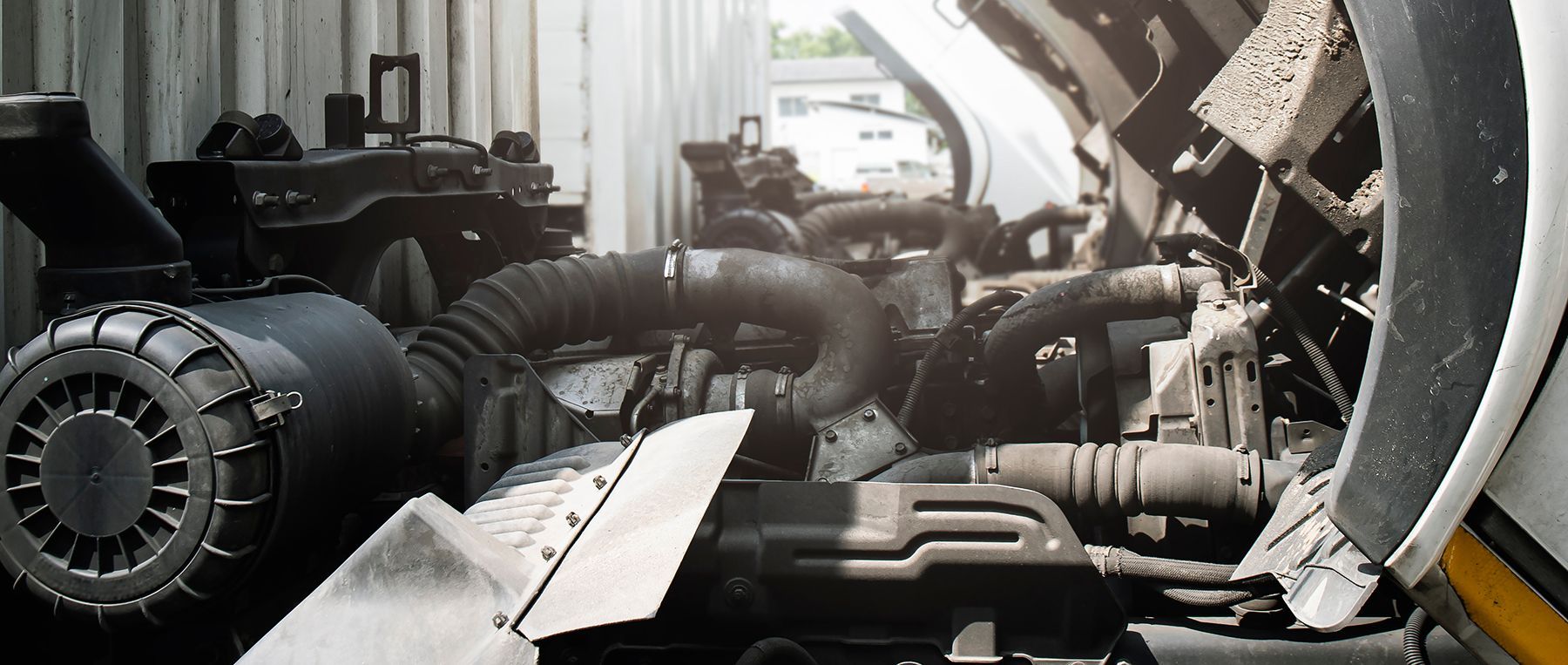 Truck engine with open hood, showing engine components and air intake.
