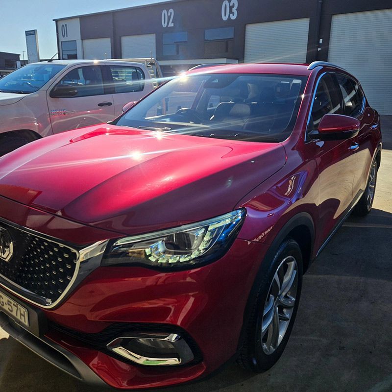 A Red Car Is Parked In Front Of A Building With The Number 03 On It — On Point Detailing Wagga in East Wagga Wagga, NSW
