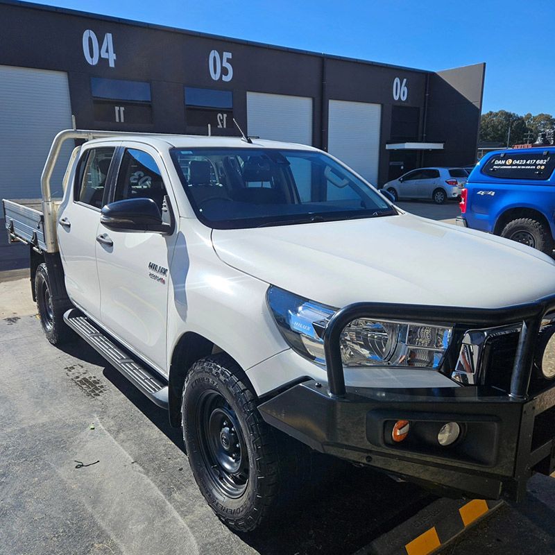A White truck is Parked in front of a Building with the numbers 04 and 05 on it — On Point Detailing Wagga in East Wagga Wagga, NSW