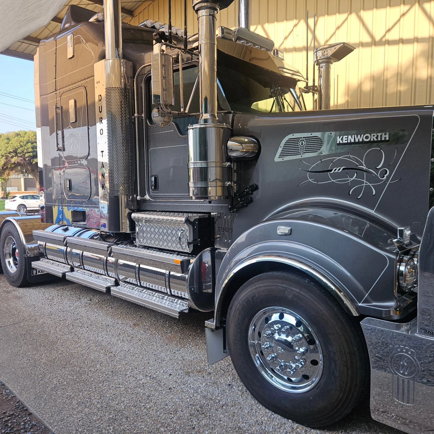 Black Kenworth semi truck parked under a shelter, side view with chrome details. — On Point Detailing Wagga in East Wagga Wagga, NSW