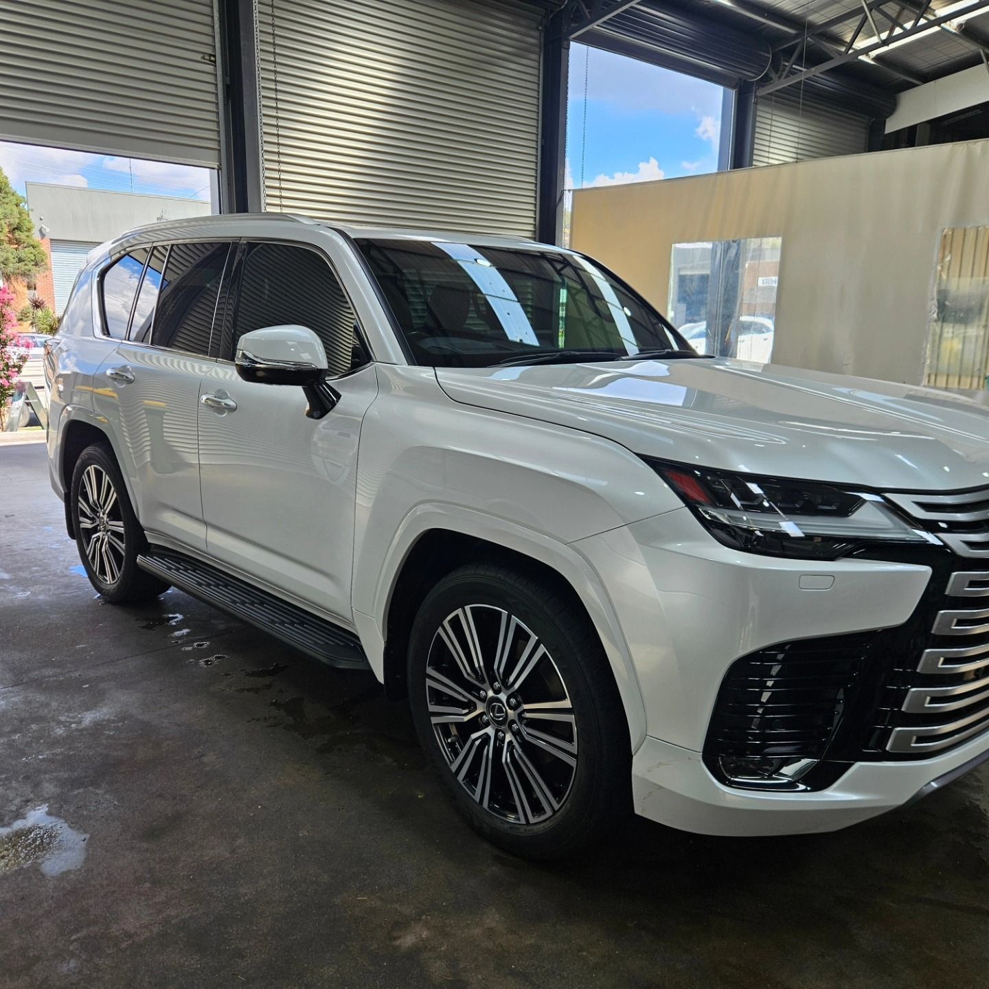 White SUV parked in a garage, front-left view with chrome accents and dark tinted windows — On Point Detailing Wagga in East Wagga Wagga, NSW