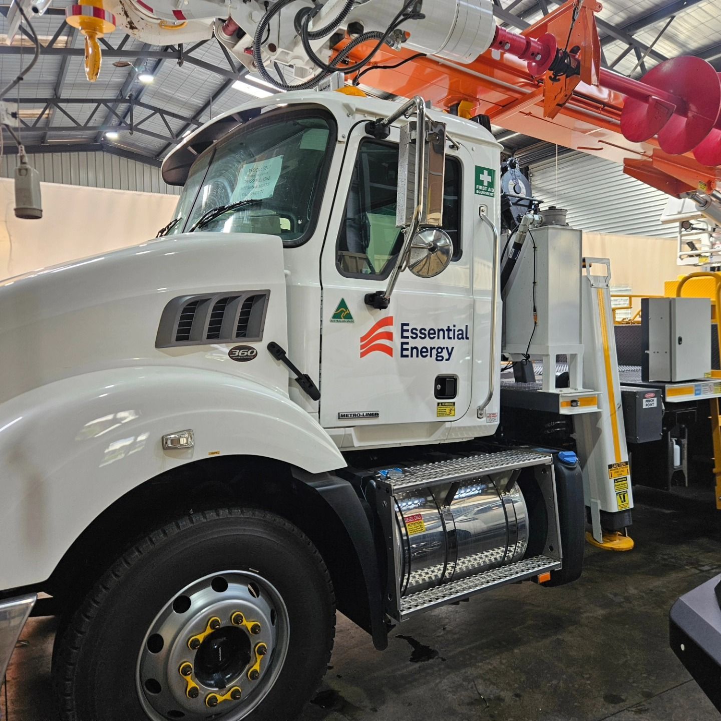 White utility truck with Essential Energy logo parked indoors under maintenance equipment — On Point Detailing Wagga in East Wagga Wagga, NSW