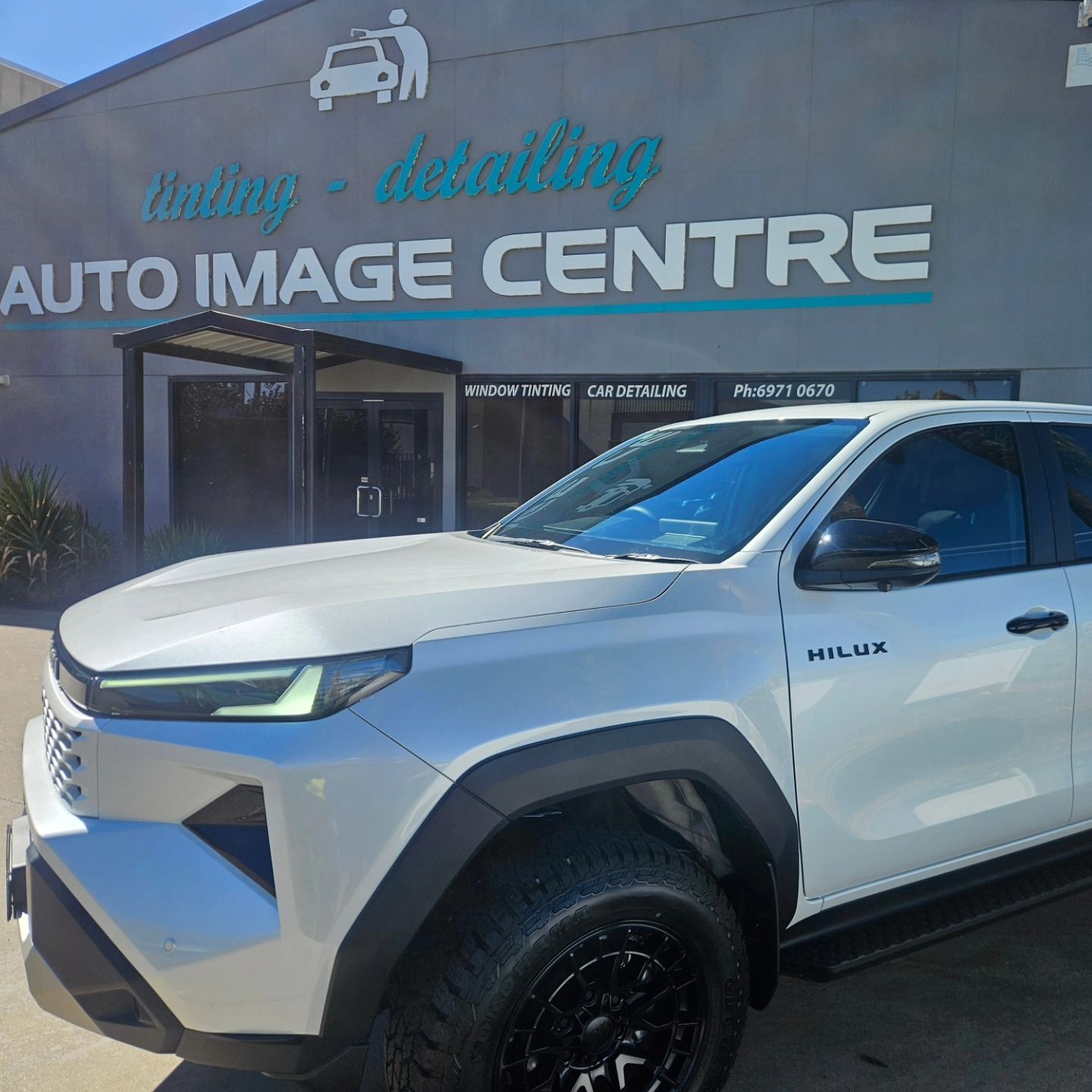 White pickup truck parked outside Auto Image Centre shop with a “window tinting - detailing” sign. — On Point Detailing Wagga in East Wagga Wagga, NSW