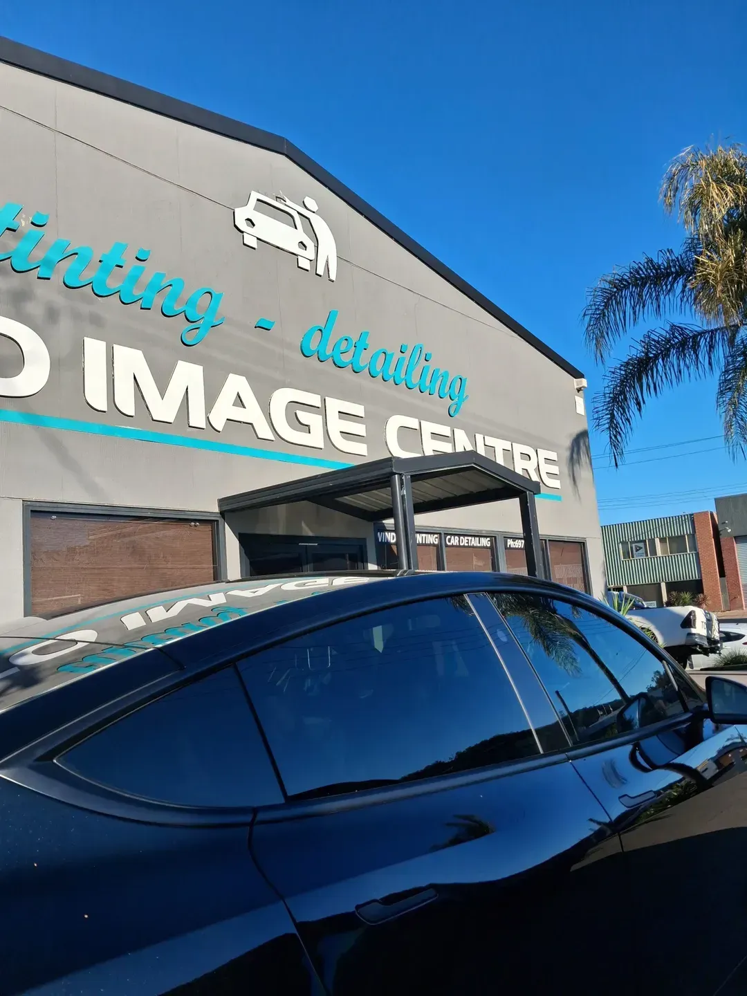 Black Car Parked Outside a Print and Image Centre with A Blue Sky — On Point Detailing Wagga in East Wagga Wagga, NSW