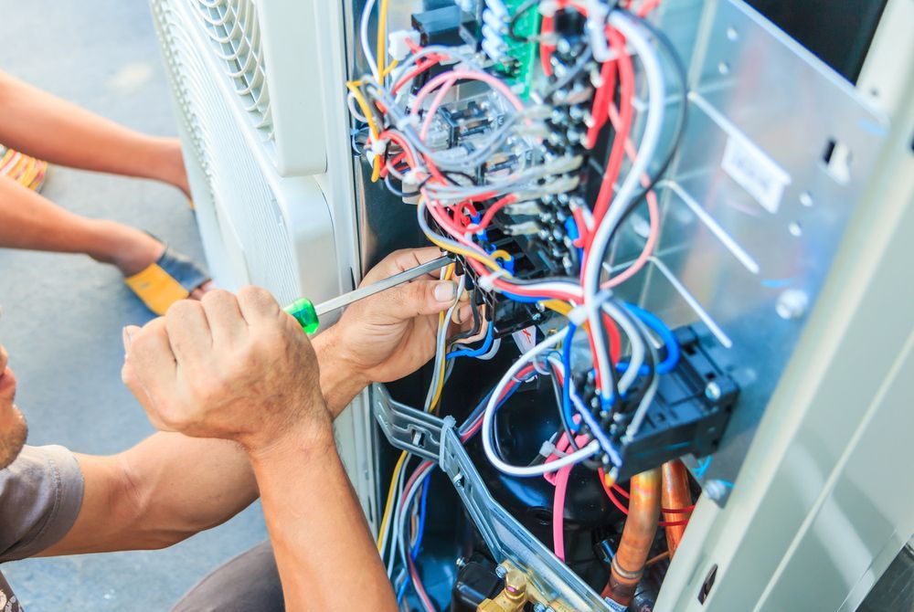 Technicians Repair Electrical Wiring of an Air Conditioning Unit — Hinterland Air Conditioning Sunshine Coast in Yandina, QLD