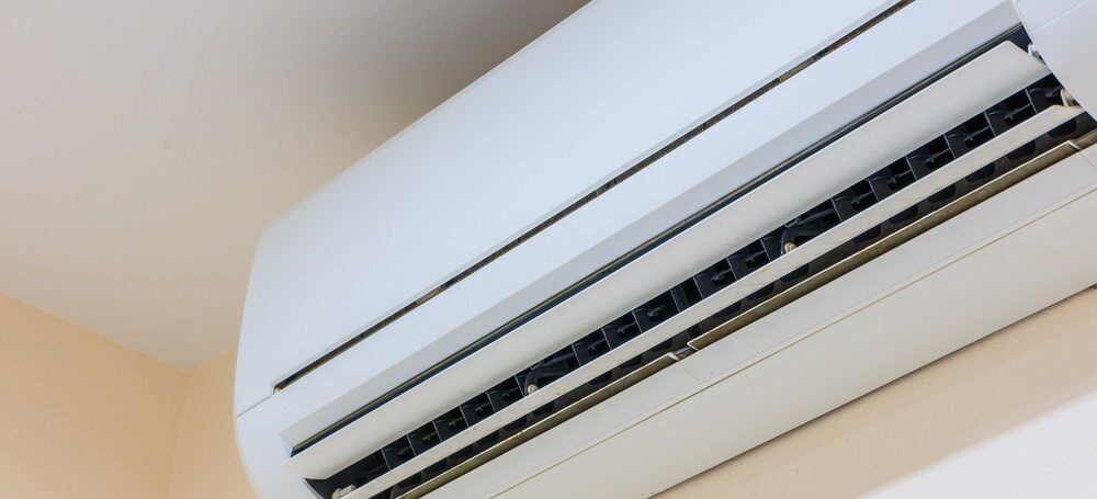 White Air Conditioner on a Light-coloured Wall — Hinterland Air Conditioning Sunshine Coast in Mons, QLD