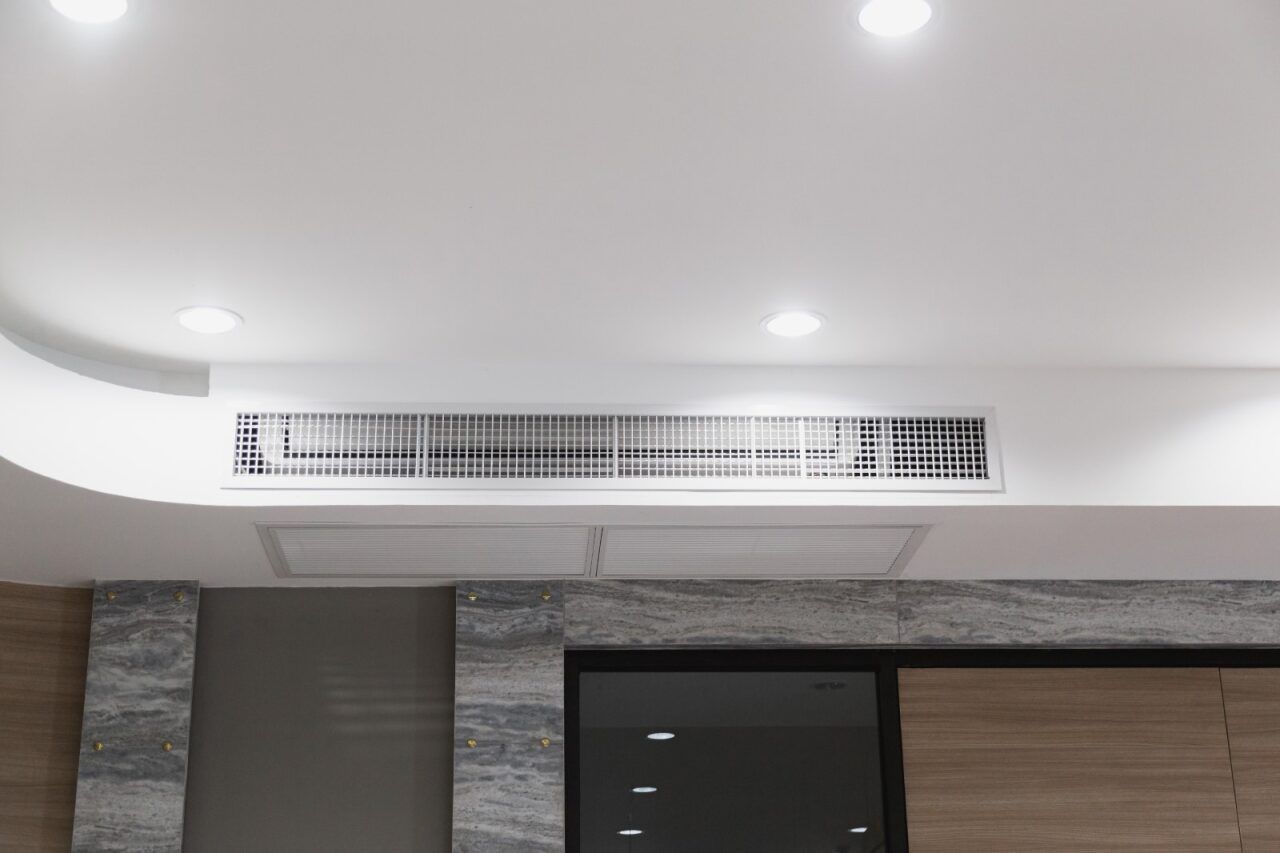 White Ceiling With Recessed Lights and a Rectangular Air Vent — Hinterland Air Conditioning Sunshine Coast in Woombye, QLD