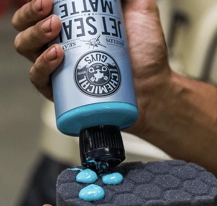 Blue gel squeezed from a bottle onto a textured black surface