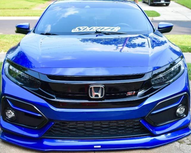 Front view of a blue Honda Civic Type R parked outdoors with a black grille and red accents