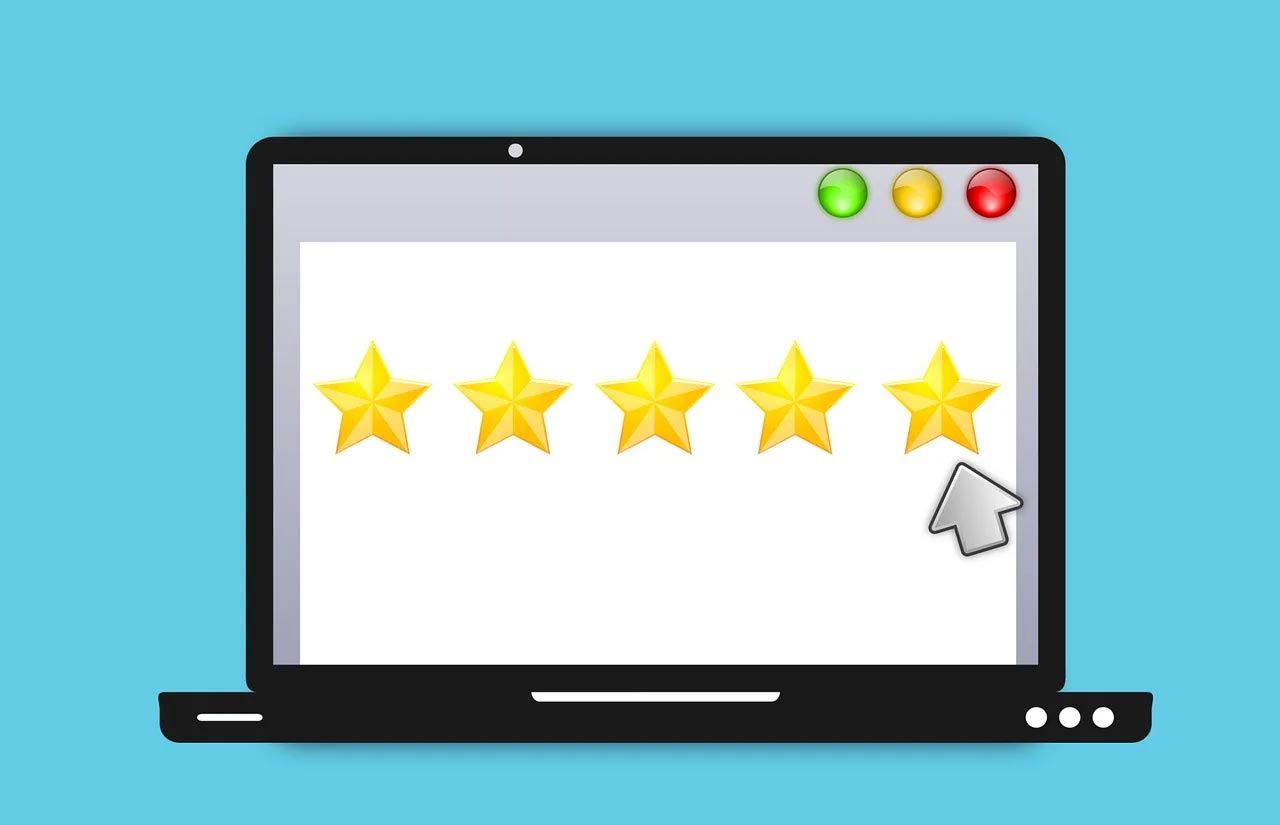 Laptop screen with five gold stars and a cursor, suggesting a 5-star rating or review.