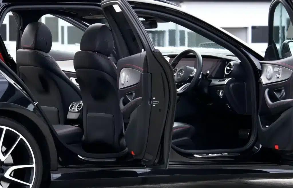 Black SUV with all four doors open, showing the interior seats and dashboard in a parking lot.