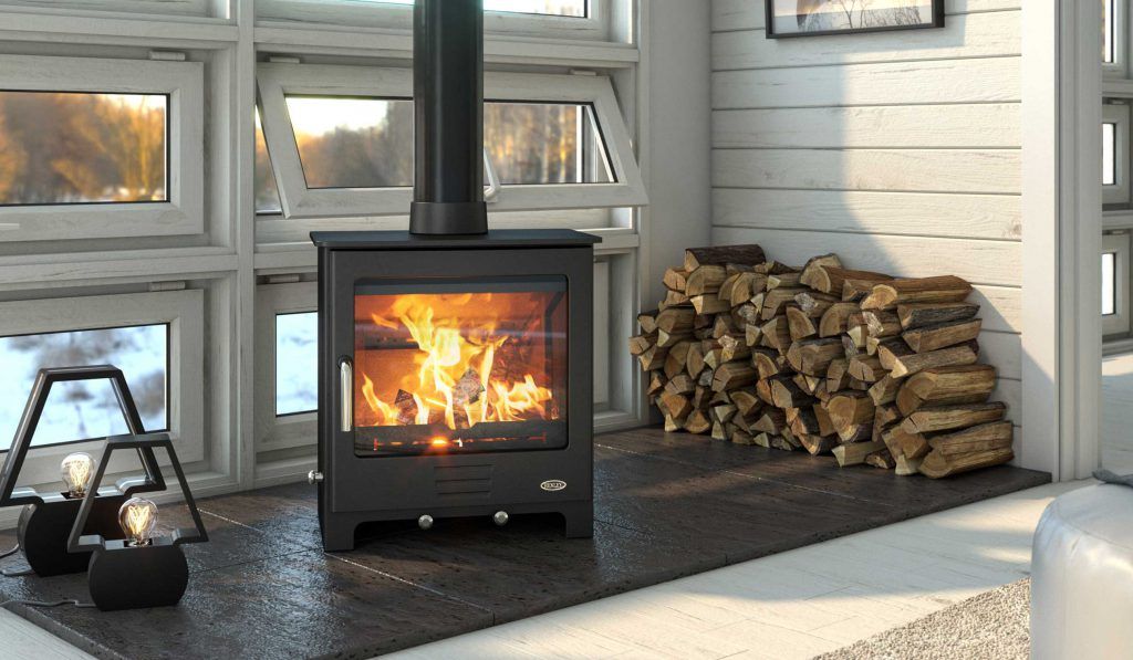 Wood burning stove with stacked logs in a bright modern room