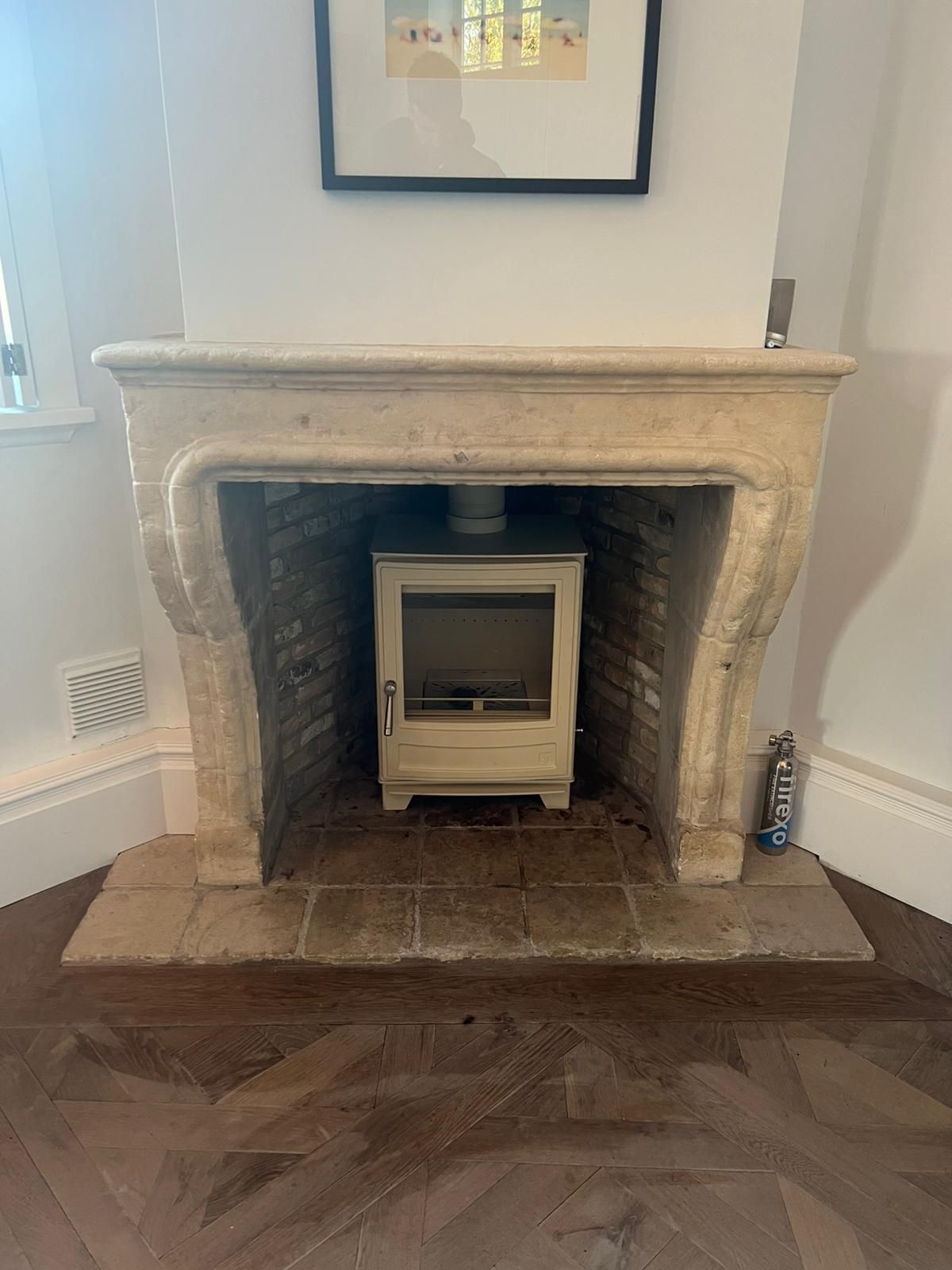 a stylish and modern fireplace surrounded by a traditional stone frame