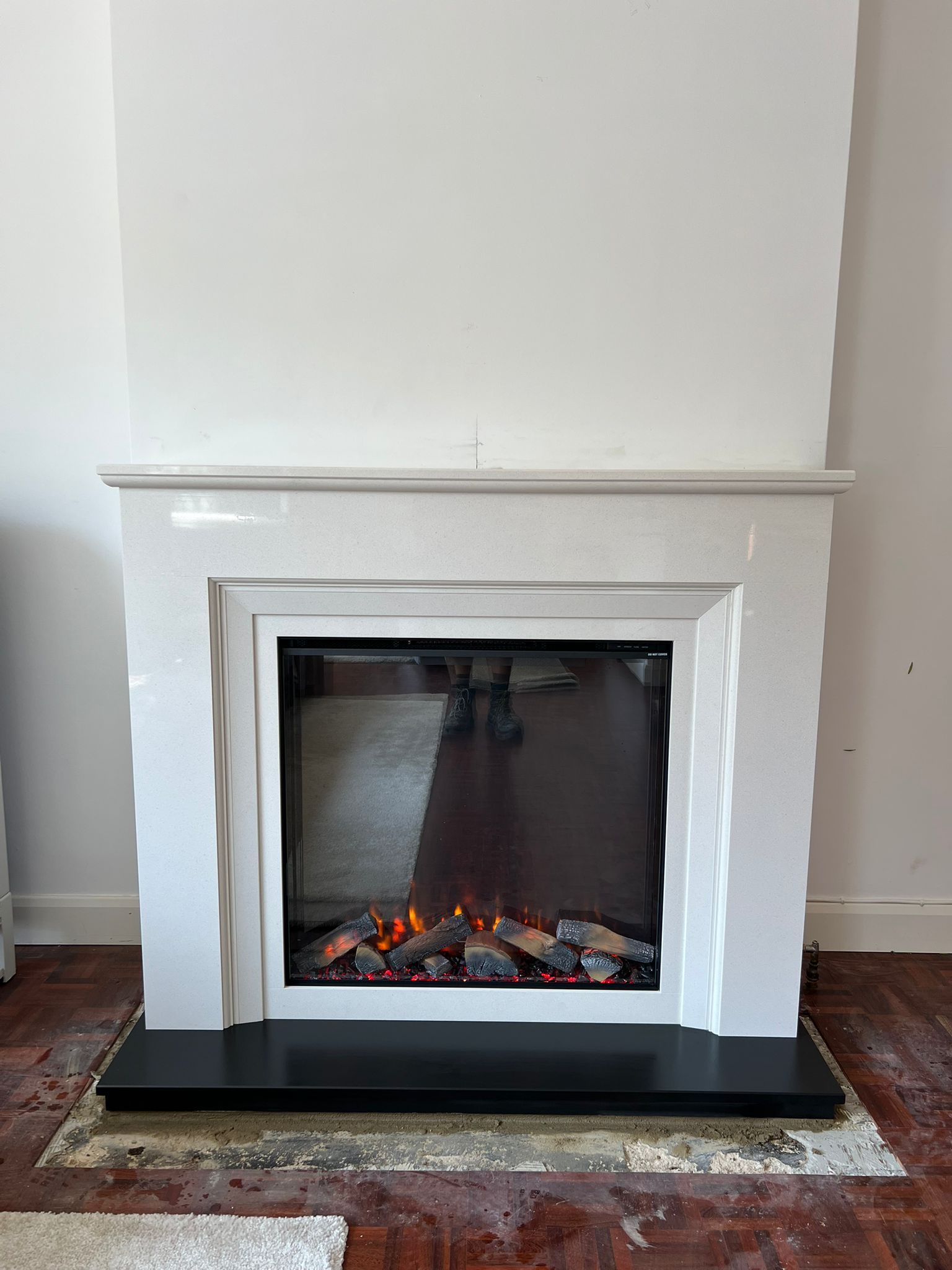 a modern electric fireplace with a sleek white frame and black base