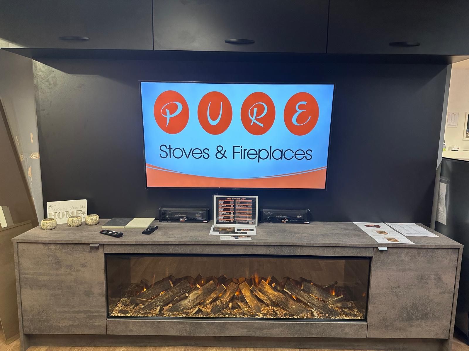 Sleek TV and electric fireplace setup with promotional material and modern design