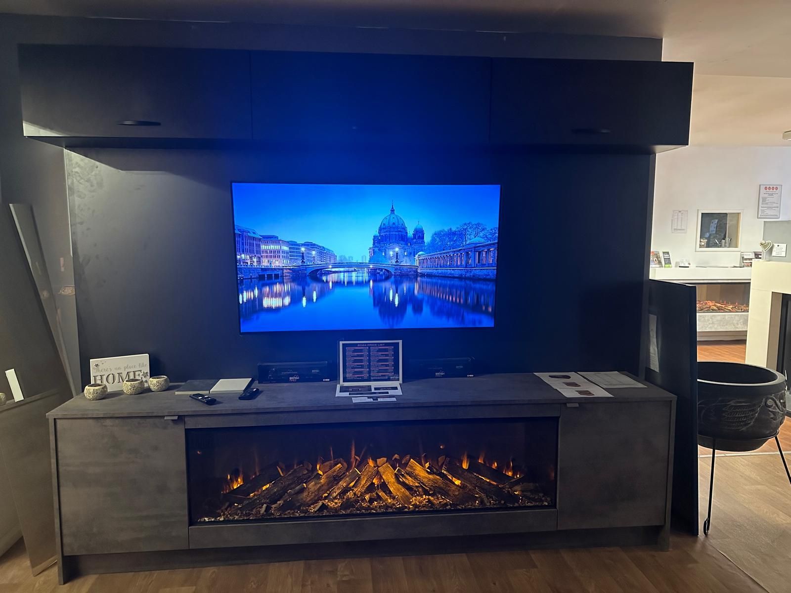 Sleek black TV wall mount with built-in electric fire feature