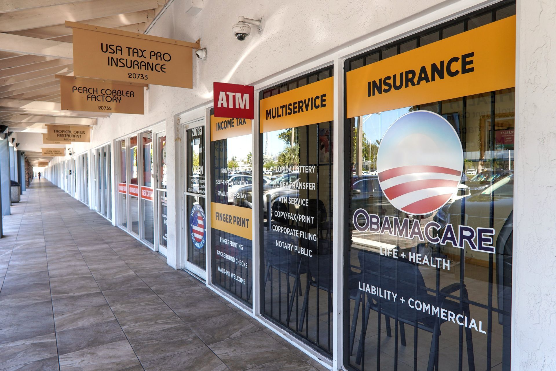 Row of storefronts; one sign reads 