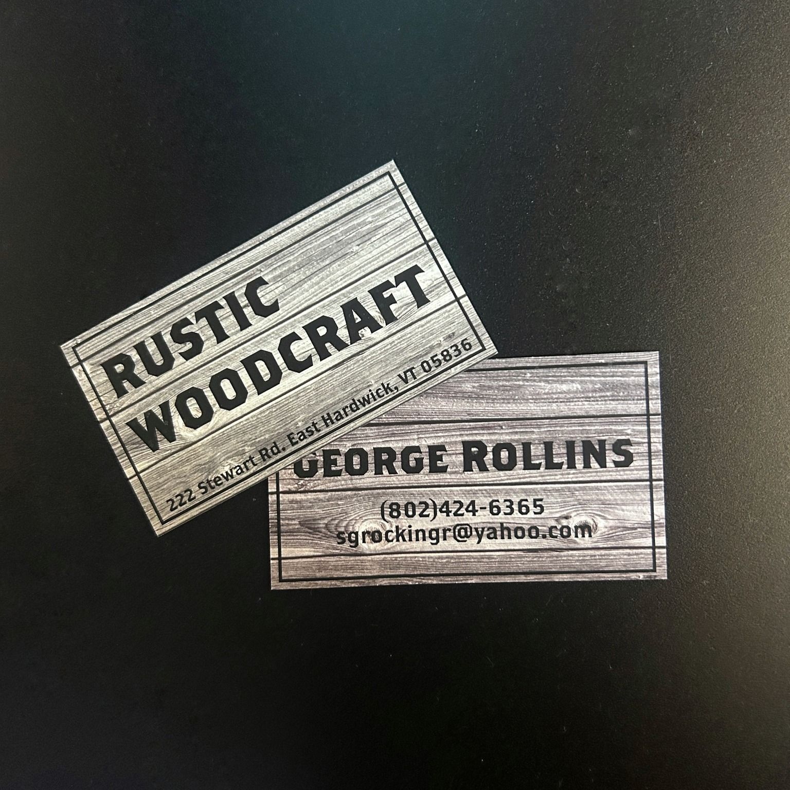 Two business cards: one for "Rustic Woodcraft" and the other for "George Rollins". Both cards have a wood grain background.