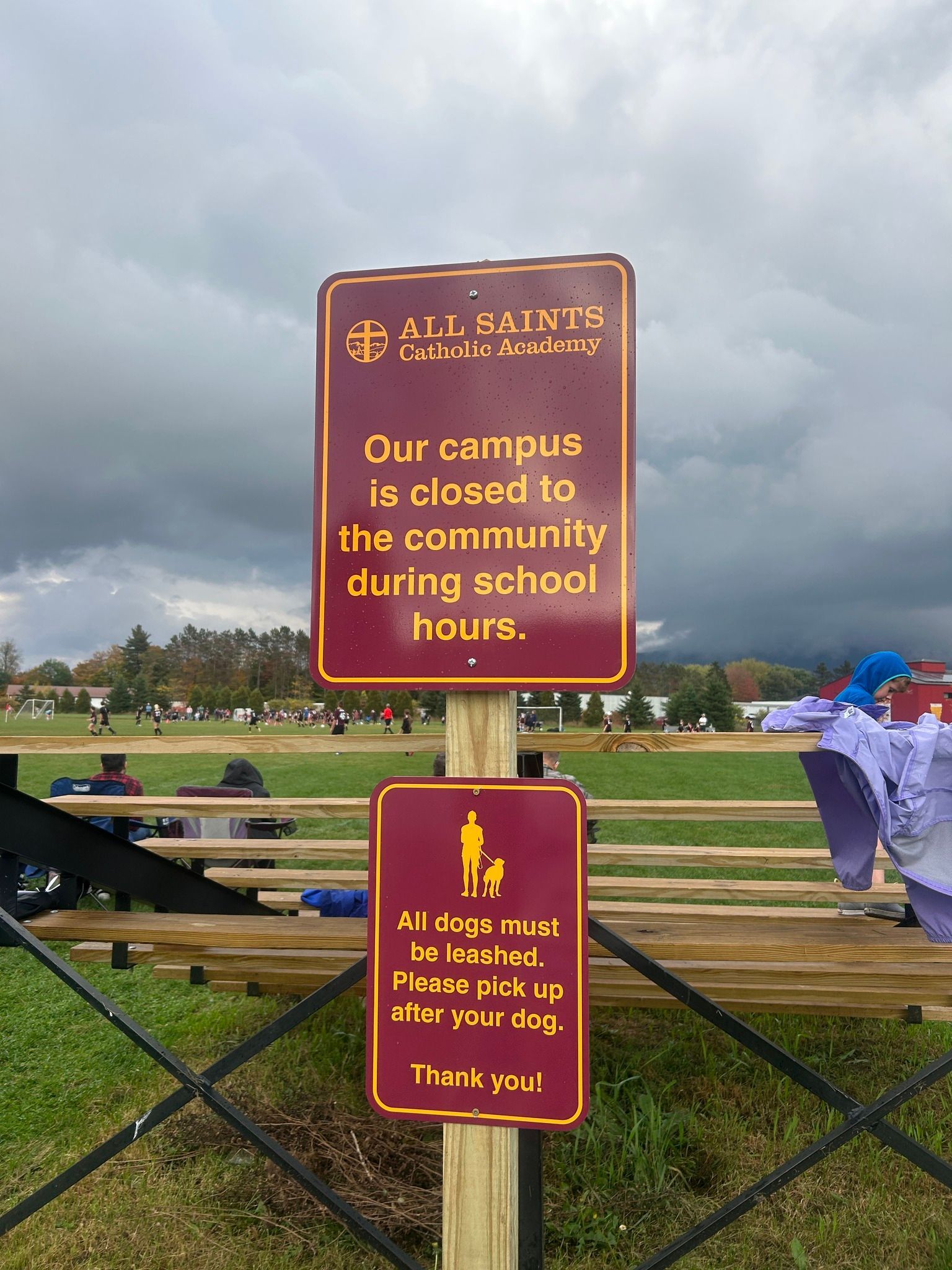 Maroon exterior wayfinding signage at a school in Northern Vermont.