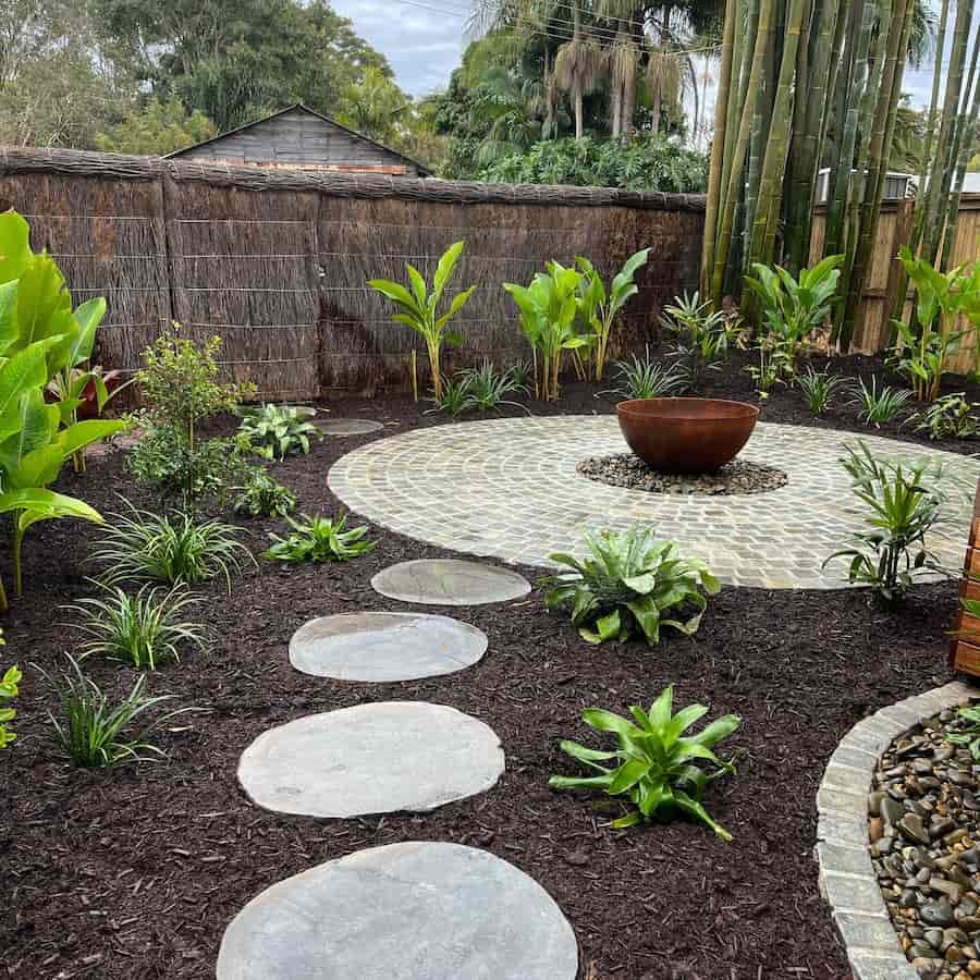 A Garden With Stepping Stones and a Fire Pit in the Middle — Bloomscapes in Lennox Head NSW