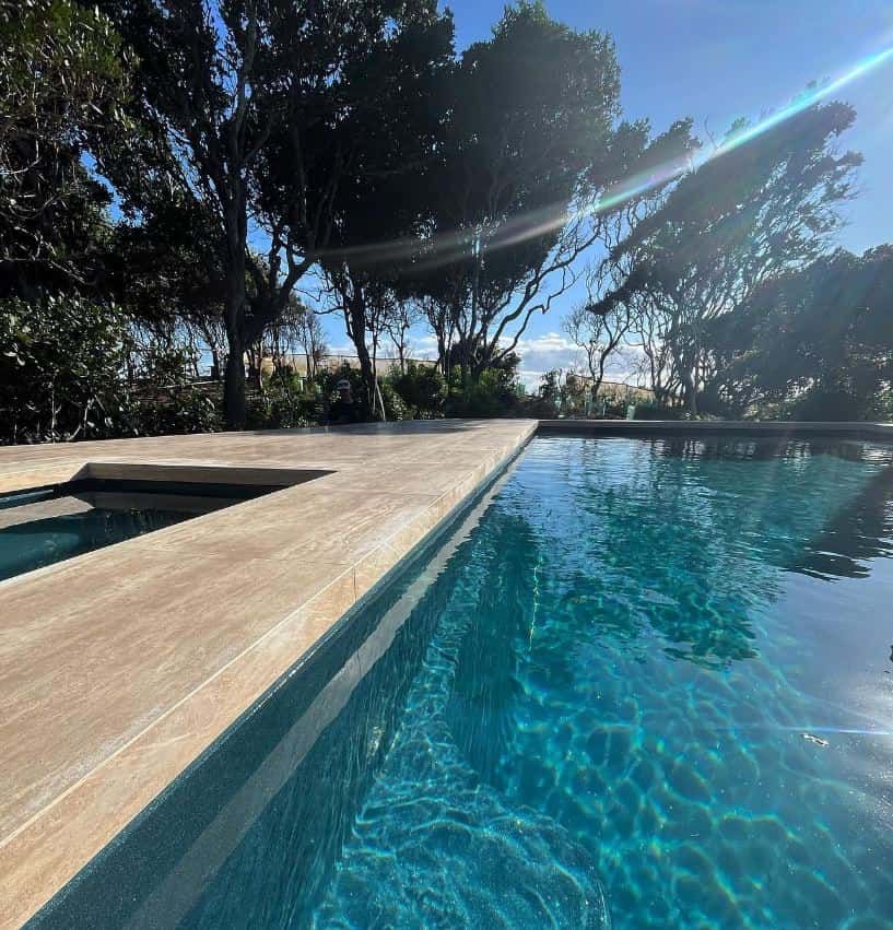 A Large Swimming Pool With Trees in the Background — Bloomscapes in Lennox Head NSW