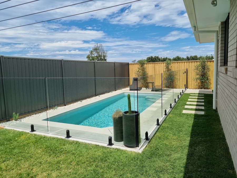 A Swimming Pool in the Backyard of a House — Bloomscapes in Lennox Head NSW