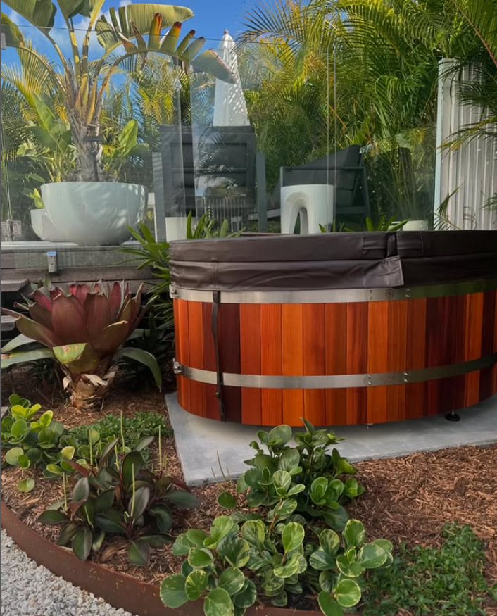 A SPA pool is in a garden surrounded by plants — Bloomscapes in Lennox Head NSW