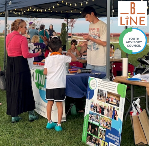 Youth Advisory Council table at Baseline's Bees & Blossoms Festival, with Baseline and Youth Advisory Council logos