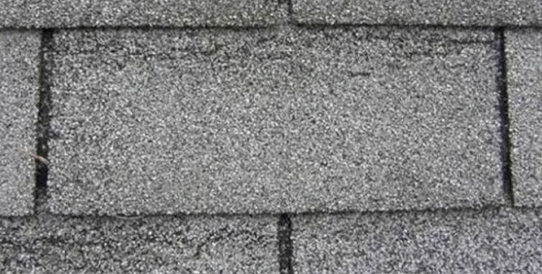 A close up of a roof with a lot of shingles on it.